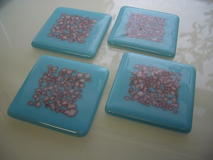 white on turquoise pebble coasters